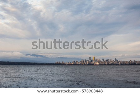 Distant view of city skyline over Vancouver harbour, Vancouver, Canada