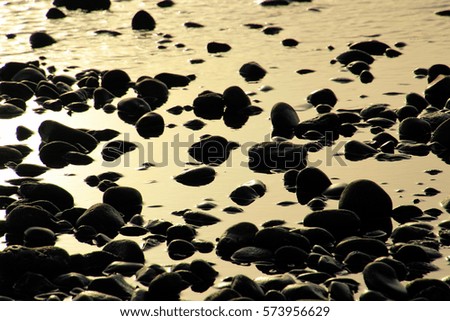 Stones and the ocean on a beach on Tenerife, Canary, Spain, Europe