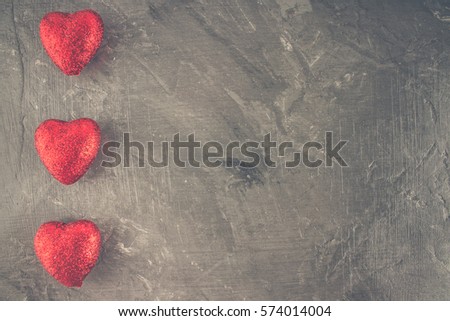 red and pink hearts on grey background.