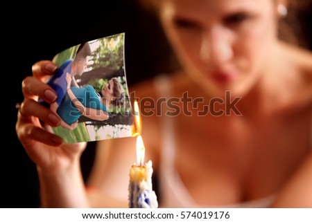 Broken heart woman. Couple break up. Sad bride on unhappy wedding. Woman and groom quarrel. Girl burns in fire candle family pictures. Portrait crying female.