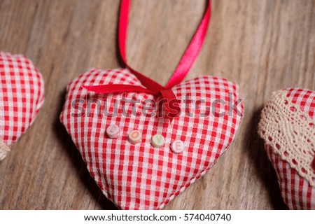 Hearts made of cloth on a wooden background. Valentines day. Valentines day greeting card.