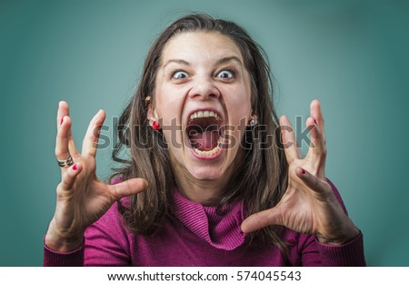 Angry woman screaming with rage, furious and dangerous Royalty-Free Stock Photo #574045543