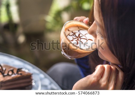 Woman drinking coffee in the corner of garden at sunshine time