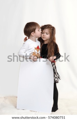 The boy and girl with a white sheet for your slogans, text, message, congratulations.