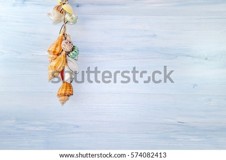 Seashells and sand on wooden board