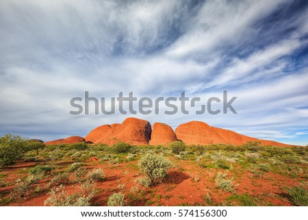Kata Tjuta or The Olgas rock formation in afternoon light under a sky with thin clouds Royalty-Free Stock Photo #574156300