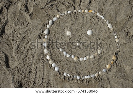 Happy face in the sand