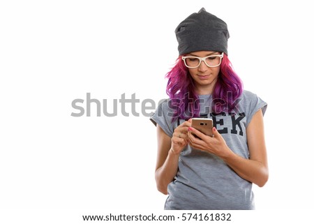 Studio shot of geek girl using mobile phone