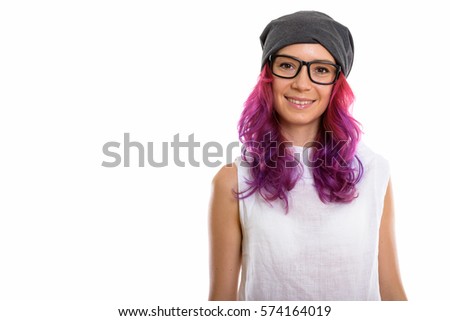 Studio shot of young happy woman smiling while wearing eyeglasses