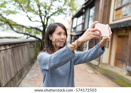 Woman take photo by mobile phone in Kanazawa