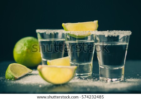 Silver Mexican tequila with lime and salt, toned picture, selective focus, close up