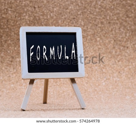 Stand blackboard written "FORMULA" with brown background.