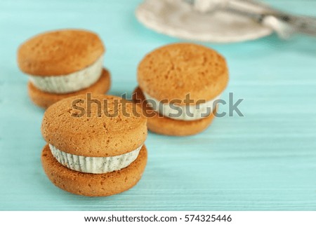 Ice cream cookie sandwiches with fresh mint on blue wooden background