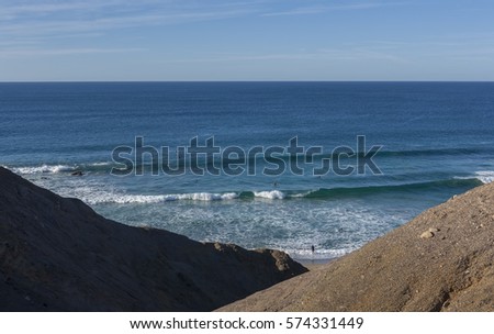 Shot of beautiful sea waves crashing on big rocks on island of Lanzarote