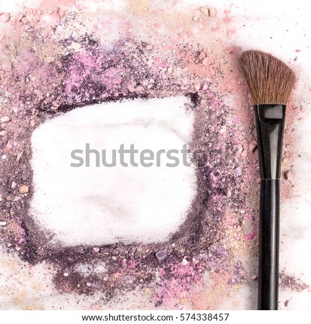 Makeup brush on white marble background, with traces of powder and blush forming a frame. A square template for a makeup artist's business card or flyer design, with copy space