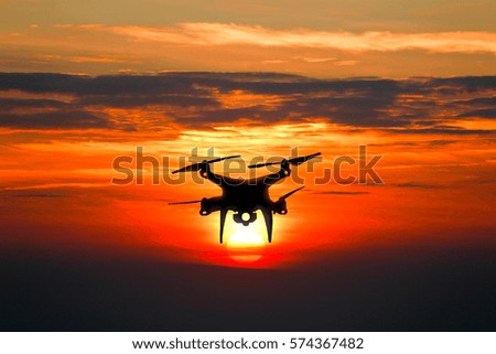 Drones flying on twilight sky sunset.