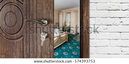 Half opened door to a bedroom, handle closeup. Welcome, privacy concept. Entrance to the hotel suit, modern interior design.