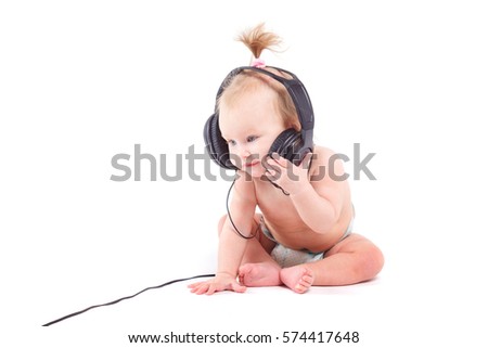 isolated on white, cute happy caucasian baby girl with ponytail, black headphones on head