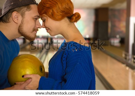 Plying with his girl. Cropped shot of a handsome young man smiling touching noses with his beautiful girlfriend while enjoying their time at the bowling club copyspace leisure love dating cuddling 