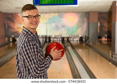 Perfect weekend. Handsome male bowling player smiling to the camera with a bowling ball in his hands copyspace leisure recreation relax happiness vitality lifestyle youth active sports concept