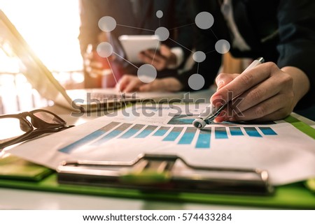 Business team meeting. Photo professional investor working new start up project. Finance task.Digital tablet docking keyboard laptop computer smart phone in morning light