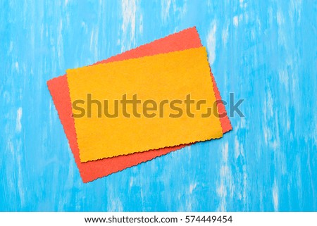 Yellow and orange diagonal cards to insert your text in on the blu background. Creative cut of paper edges. To make a card.
