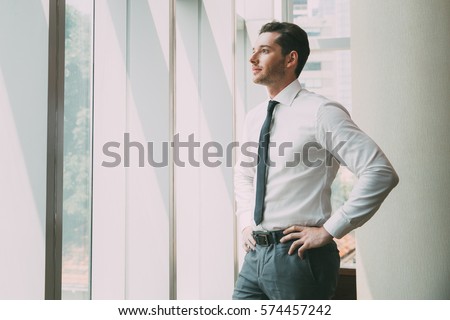 Portrait of Businessman at Window 4 Royalty-Free Stock Photo #574457242