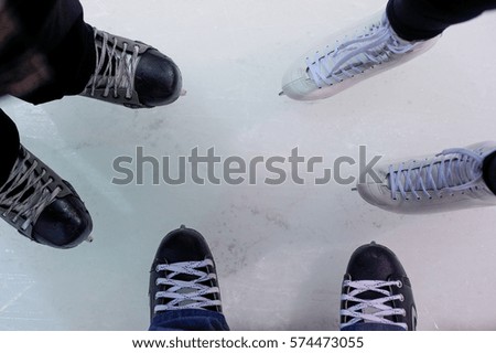 Two Hockey skates and one figure skate on ice