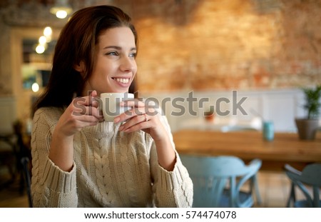 woman in a cafe drinking coffee Royalty-Free Stock Photo #574474078