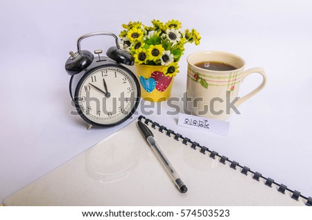Coffee mug with sunflowers and notes good morning in bengali language on white background.
