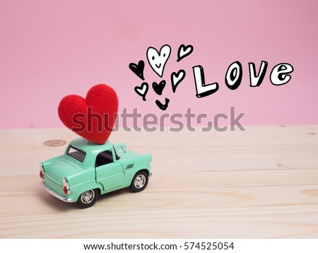 A gift box on color background and top wood table for Christmas and The New Year and Valentine's day .Decoration love heart and drawing free hand cartoon cute love.