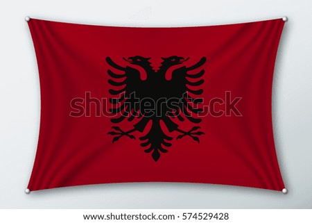 Albania national flag. Symbol of the country on a stretched fabric with waves attached with pins. Realistic vector illustration.