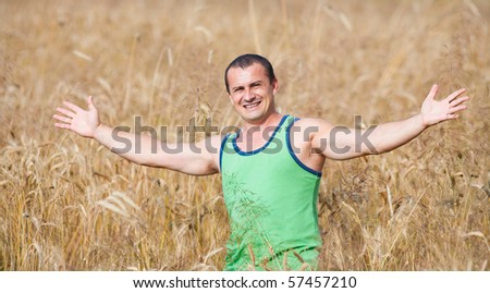 Portrait of a young farmer in his wheat field