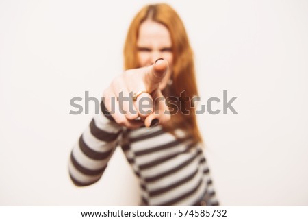 studio portrait of a beautiful girl pointing to the camera