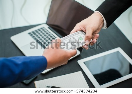 Businessman hand sending money agreed to work.