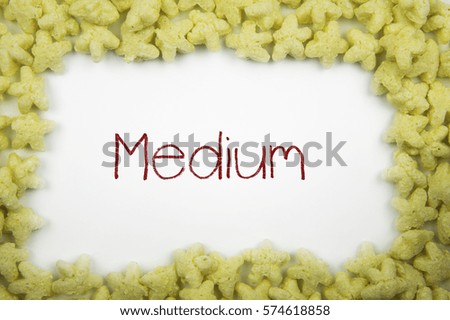 MEDIUM concept write text in frame of glazed crispy snacks in shape of stars