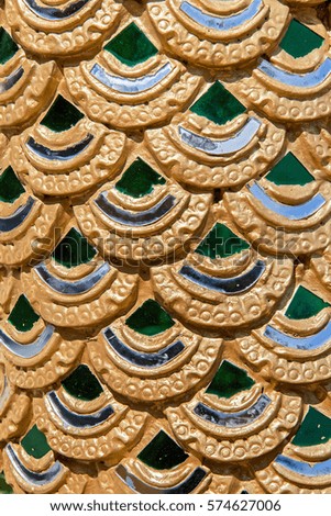 Close-up view decoration Buddhist temple. Gilded scales statue of a dragon in a Buddhist monastery, Thailand