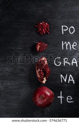 Top view picture of pomegranate over dark chalkboard background