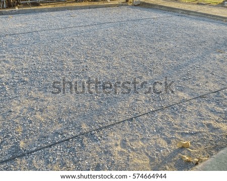 gravel ground of petanque field with sunlight shine on the ground in the evening.