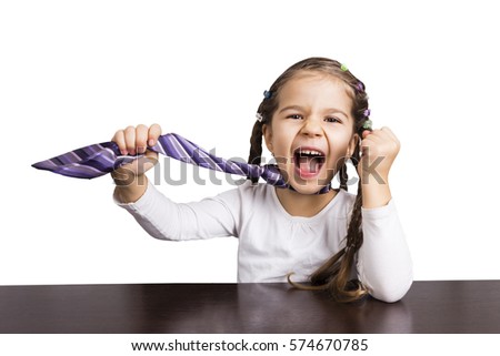 Cute girl sitting at table and doing home tasks
