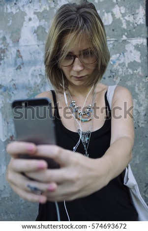 Young woman taking selfie with a phone