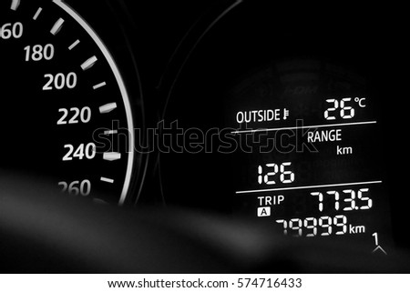 car dashboard showing speedometer and distance information Royalty-Free Stock Photo #574716433