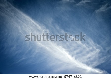 clouds creating seamless pattern in the blue sky.