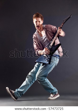 picture of a passionate guitarist playing on dark background