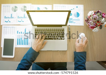 Businessman working at office desk and using a digital tablet, computer, laptop and many documen new project plan of business.