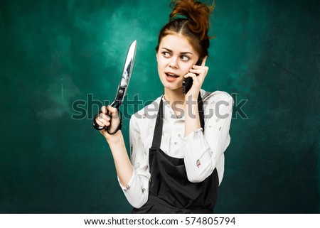 Housewife with scissors in hand speaking with cell phone in hand