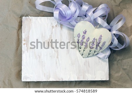 Decorative heart with lavender picture and violet ribbon on white wooden desk. Valentine's day, 14 february holiday concept. symbol of love, romance. rustic provence style. flat lay. copy space