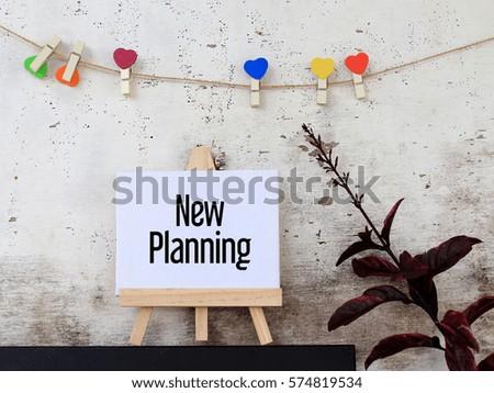 New Planning - business concept words on canvas stand. rustic wooden background