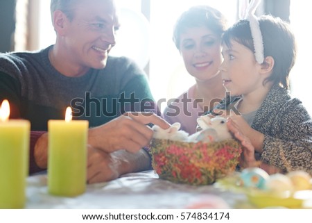 Little kid talking to his parents on Easter evening