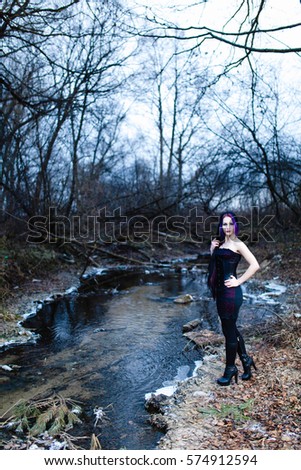 Portrait of the gothic woman near the cold creek